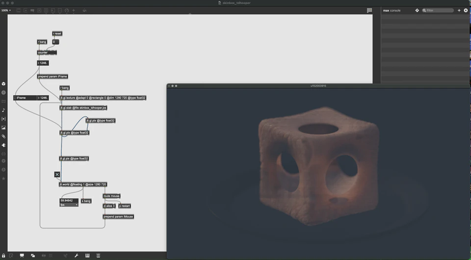 Max/MSP/Jitter patcher beside a porous brown cube on a dark background