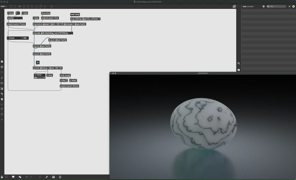 Max/MSP/Jitter patcher with a marbled pale orb resting on a reflective dark surface.